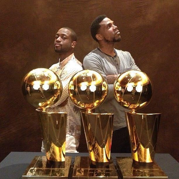 Udonis Haslem (standing right) with his 3 NBA Title trophies