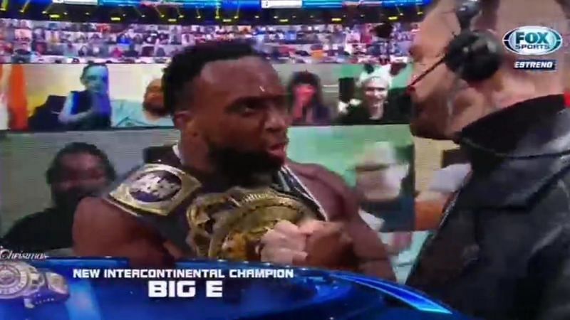 Big E would walk up to the announce desk to share a moment with Corey Graves