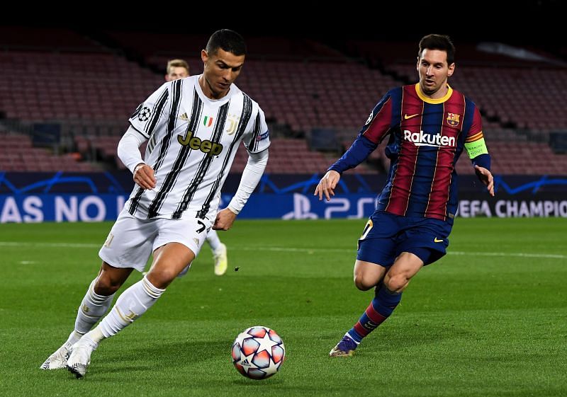 Cristiano Ronaldo of Juventus F.C. is put under pressure by Lionel Messi of Barcelona