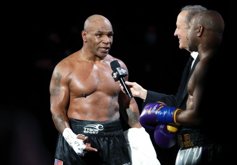 Mike Tyson celebrates after receiving a split draw against Roy Jones Jr.