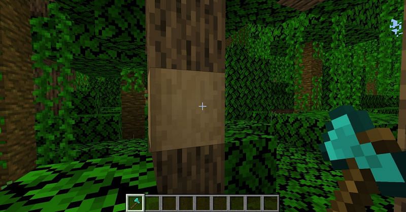 Stripping the bark off a jungle log in Minecraft with a diamond axe. (Image via Minecraft)