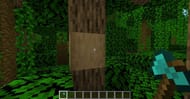Stripping the bark off a jungle log in Minecraft with a diamond axe. (Image via Minecraft)