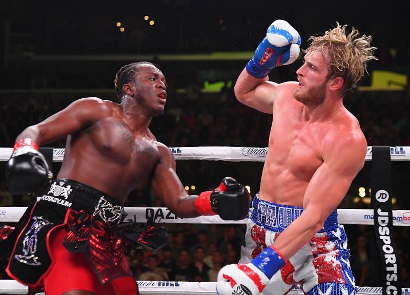 Logan Paul (red/white/blue shorts) and KSI (black/red shorts) exchange punches
