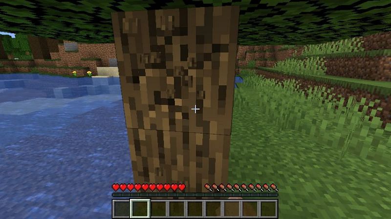 Punching a tree for a wood log in Minecraft. (Image via Minecraft)