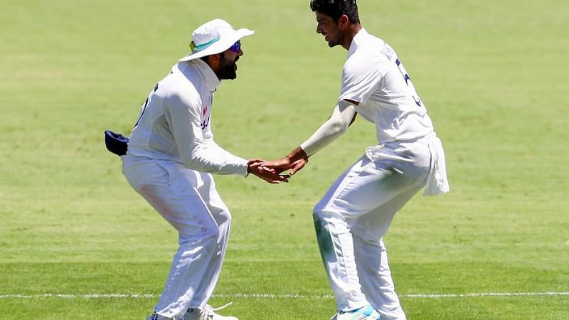 Washington Sundar celebrates with Rohit Sharma after picking Steve Smith for his maiden Test wicket