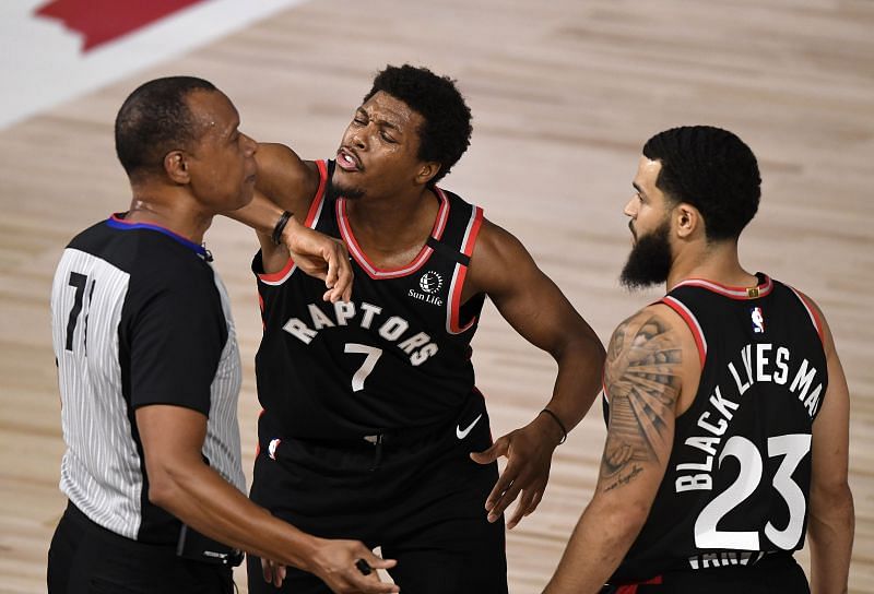 Kyle Lowry of the Toronto Raptors talks with the referee during the first quarter against the Boston Celtics as Fred VanVleet looks on in Game Three of the 2020 Eastern Conference Second Round