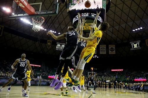 Matthew Mayer #24 of the Baylor Bears shoots the ball against Levi Stockard III #34 of Kansas State