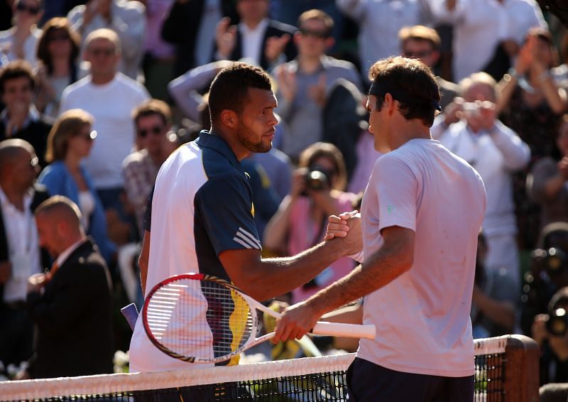 Jo-Wilfried Tsonga (L) and Roger Federer following their quarterfinal encounter at French Open 2013
