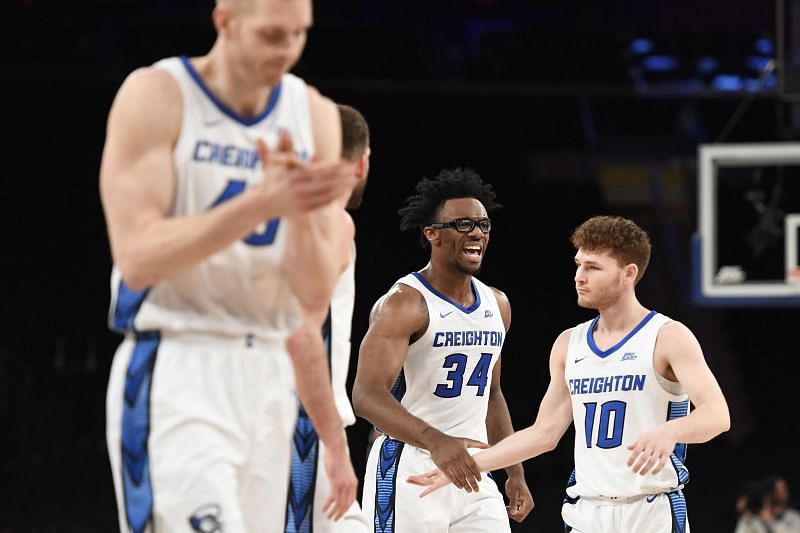 Denzel Mahoney #34 high-fives Jett Canfield #10 of the Creighton Bluejays