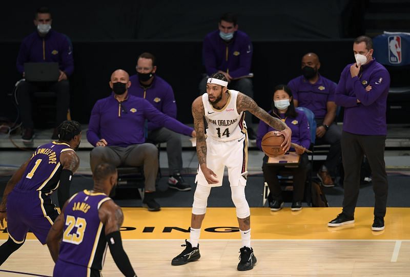 Brandon Ingram (#14) of the New Orleans Pelicans dribbles in front of the LA Lakers bench.