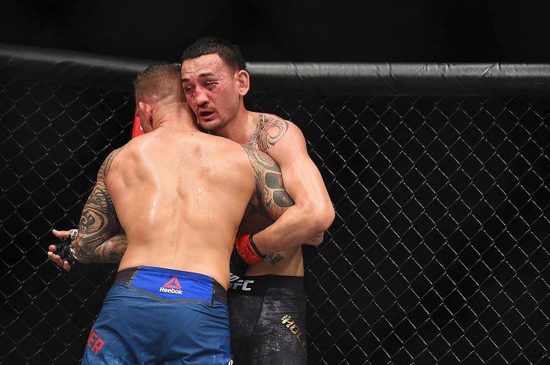 Dustin Poirier holding Max Holloway in a clinch