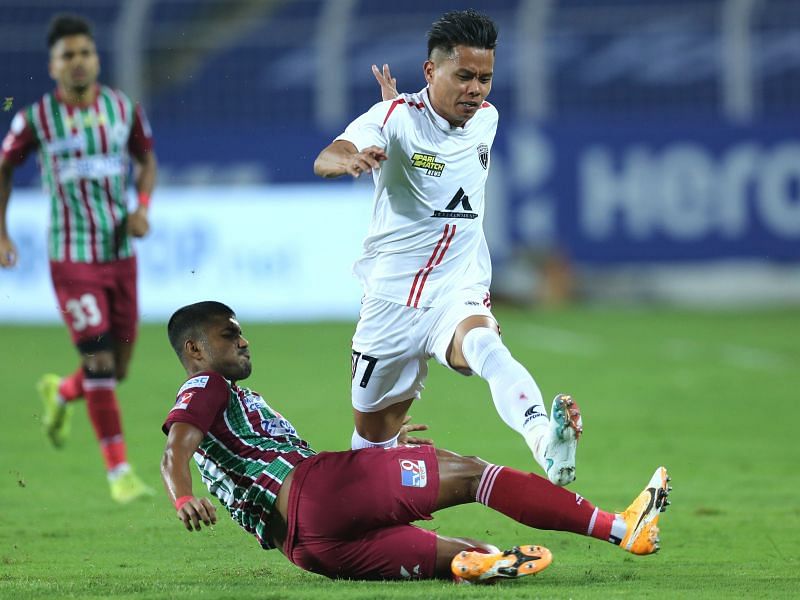 ATK Mohun Bagan's Pritam Kotal lunges in a sliding tackle on a NorthEast United FC player (Image Courtesy: ISL Media)