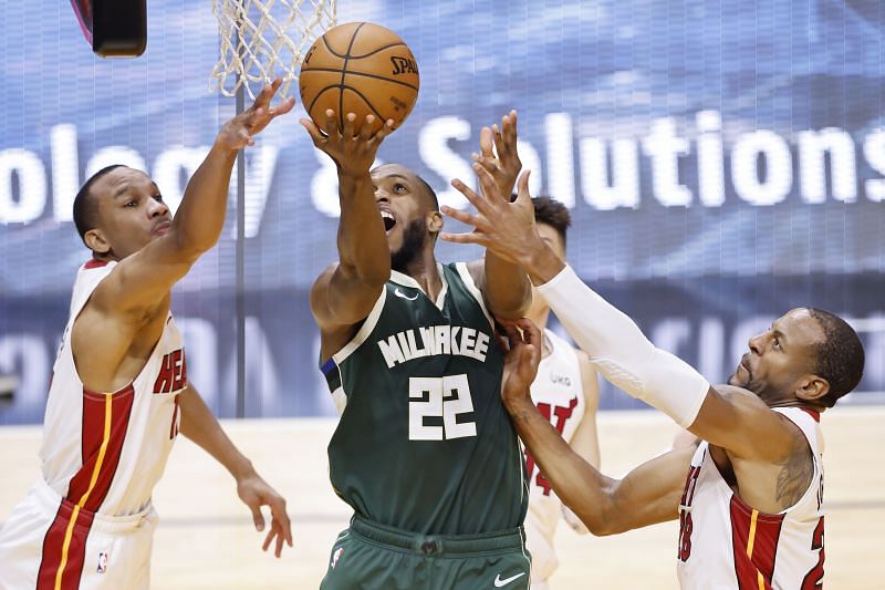 Khris Middleton #22 of the Milwaukee Bucks goes up for a layup against Avery Bradley #11 and Andre Iguodala #28 of the Miami Heat (Photo by Michael Reaves/Getty Images)