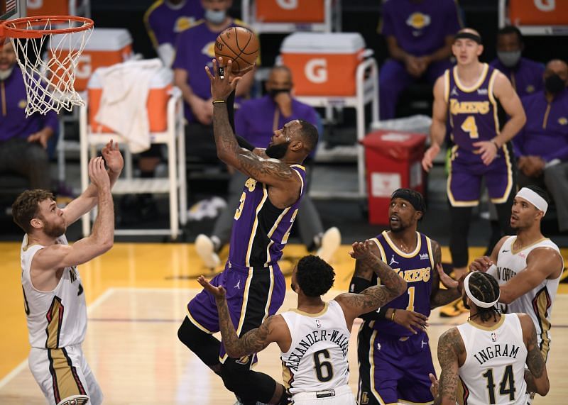 LeBron James #23 of the LA Lakers scores in front of Nicolo Melli #20 and Nickeil Alexander-Walker #6 of the New Orleans Pelicans at Staples Center on January 15, 2021 (Photo by Harry How/Getty Images)