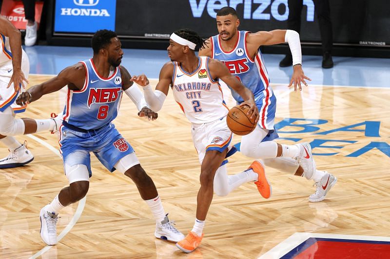 Shai Gilgeous-Alexander faces a double team against the Brooklyn Nets.