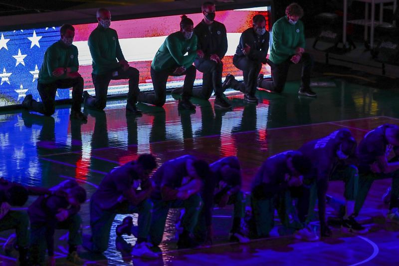 Boston Celtics players and support staff take the knee prior to a match against the New York Knicks