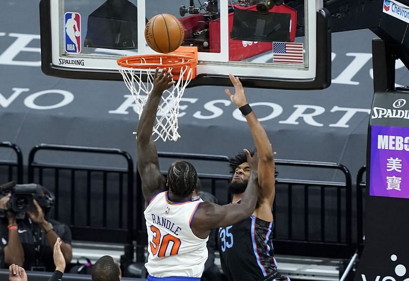 Julius Randle of the New York Knicks shoots and scores while being fouled by Marvin Bagley III of the Sacramento Kings