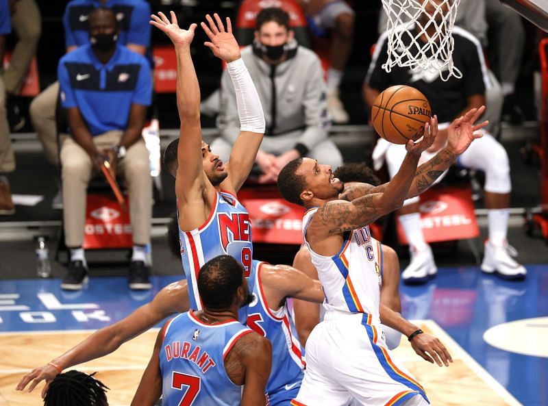 George Hill #3 of the Oklahoma City Thunder shoots as Timothe Luwawu-Cabarrot #9 of the Brooklyn Nets defends.