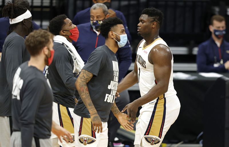 Zion Williamson #1 of the New Orleans Pelicans is congratulated by teammates as he comes to the bench.