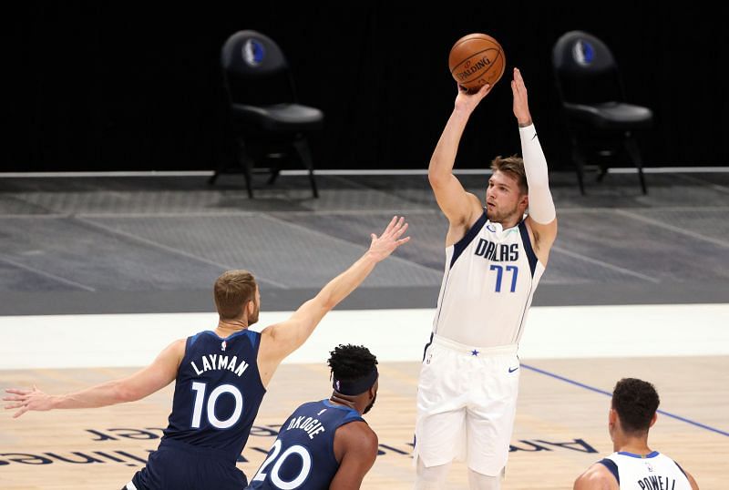 Luka Doncic #77 of the Dallas Mavericks takes a shot against Jake Layman #10 of the Minnesota Timberwolves.