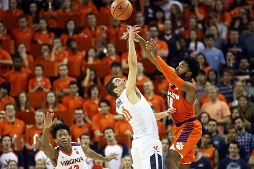 Virginia Cavaliers' player tips a pass by the Clemson Tigers' player