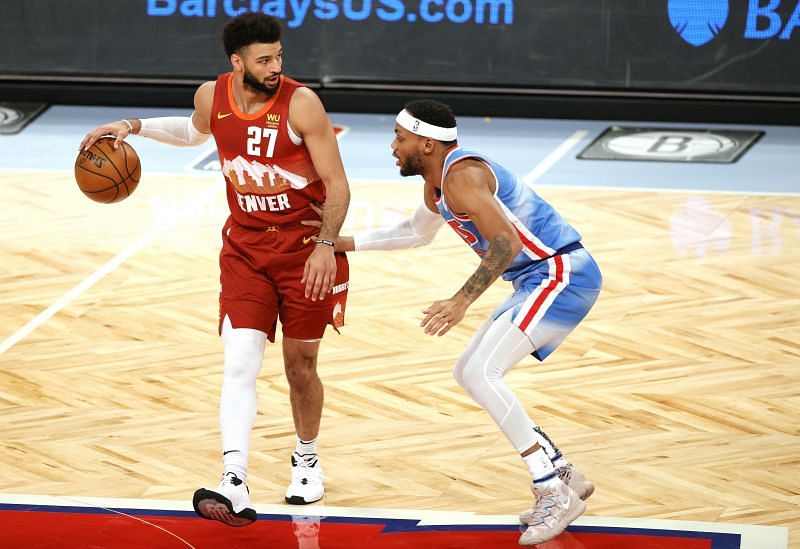 Jamal Murray #27 of the Denver Nuggets dribbles as Bruce Brown #1 of the Brooklyn Nets defends