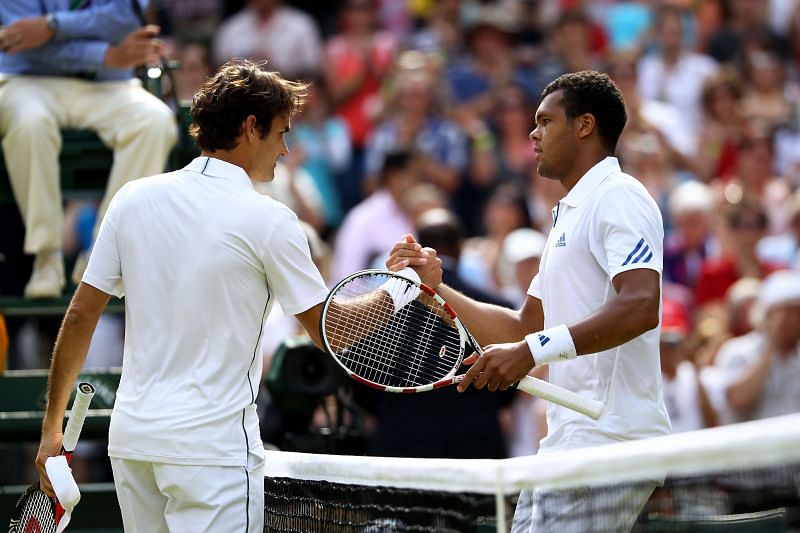 Roger Federer (L) and Jo-Wilfried Tsonga following their quarterfinal encounter at Wimbledon 2011