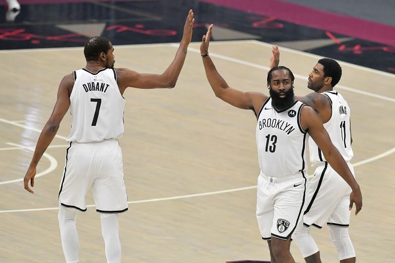 Kevin Durant, James Harden, and Kyrie Irving of the Brooklyn Nets celebrate during the first quarter against the Cleveland Cavaliers at the Rocket Mortgage Fieldhouse.