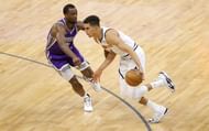 Michael Porter Jr. #1 of the Denver Nuggets is guarded by Harrison Barnes #40 of the Sacramento Kings.
