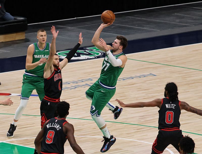 Luka Doncic #77 of the Dallas Mavericks takes a shot against Zach LaVine #8 of the Chicago Bulls.