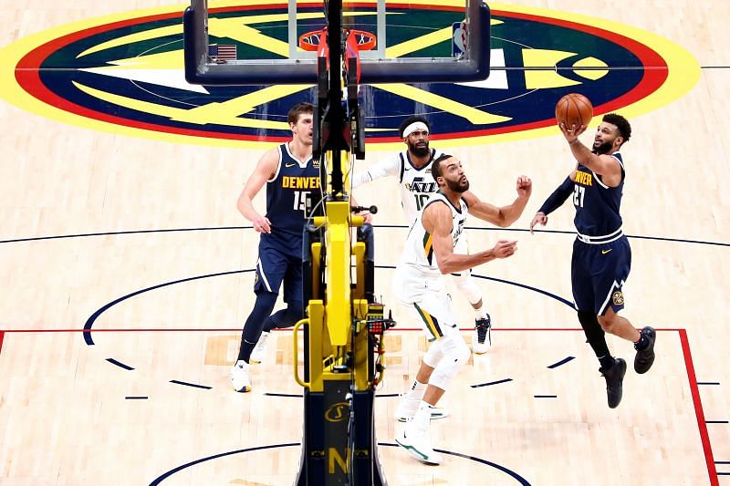 Jamal Murray #27 of the Denver Nuggets drives past Rudy Gobert #27 of the Utah Jazz at Ball Arena (Photo by Jamie Schwaberow/Getty Images)
