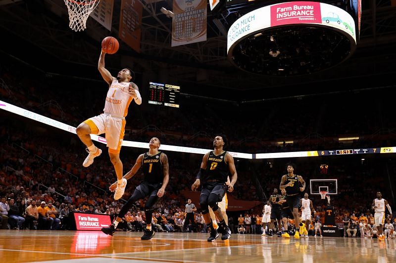 Tennessee Volunteers dunks the ball in front of Xavier Pinson #1 of the Missouri Tigers