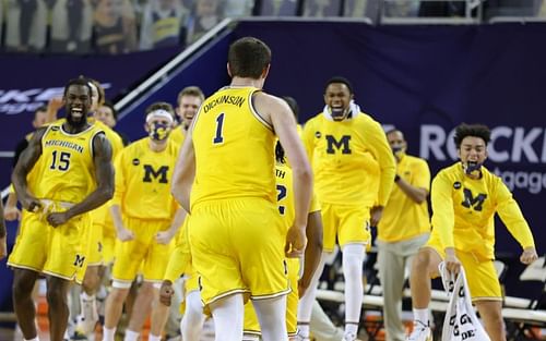 Hunter Dickinson #1 of the Michigan Wolverines running to celebrate with teammates