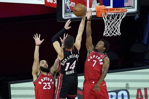  Tyler Herro #14 of the Miami Heat shoots between Fred VanVleet #23 and Kyle Lowry #7 of the Toronto Raptors during a game at HP Field House on August 3, 2020 (Photo by Ashley Landis-Pool/Getty Images)