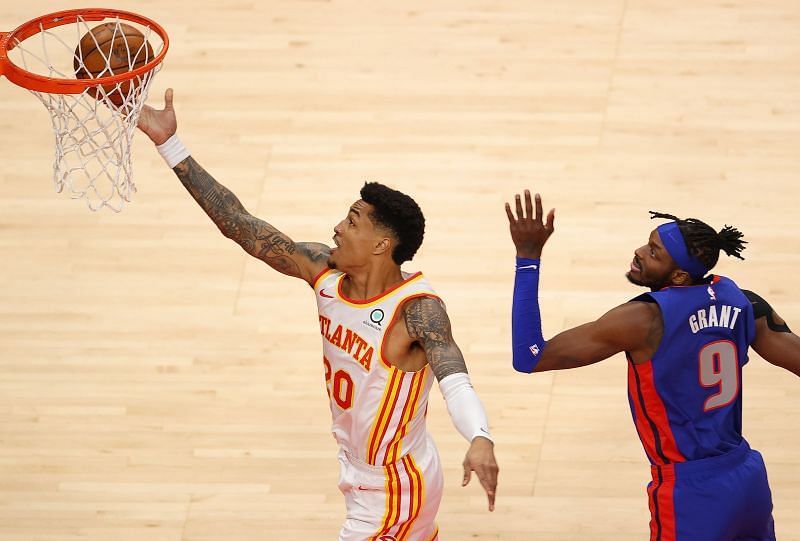 John Collins #20 of the Atlanta Hawks attacks the basket against Jerami Grant #9 of the Detroit Pistons during the first half at State Farm Arena on January 20, 2021 in Atlanta, Georgia. (Photo by Kevin C. Cox/Getty Images)