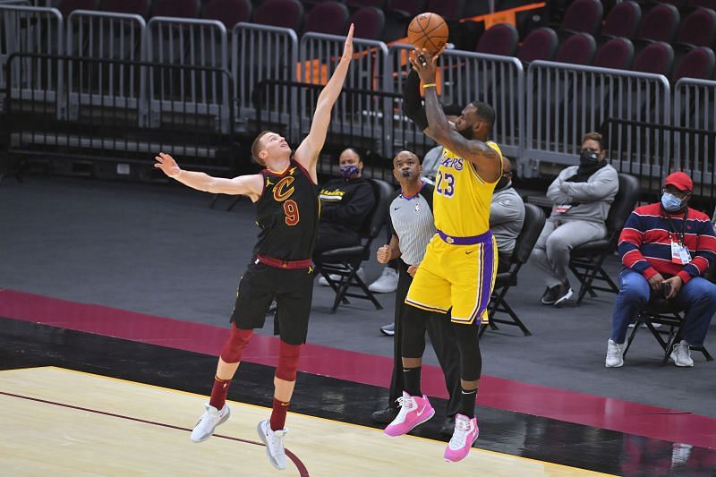 LeBron James #23 of the Los Angeles Lakers shoots over Dylan Windler #9 of the Cleveland Cavaliers.