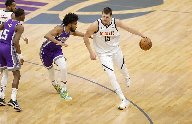 Nikola Jokic #15 of the Denver Nuggets is guarded by Marvin Bagley III #35 of the Sacramento Kings.