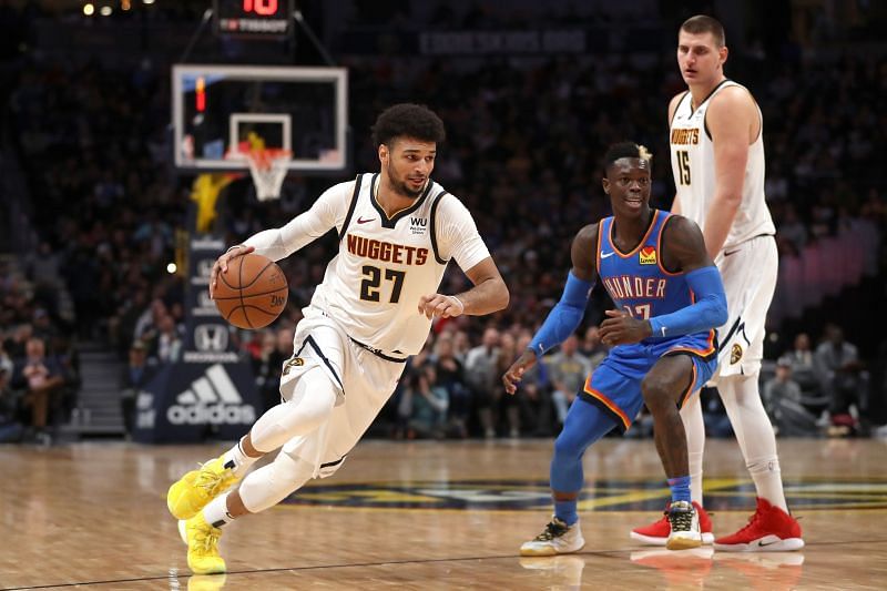 Jamal Murray of the Denver Nuggets drives past Dennis Schroder off a pick set by Nikola Jokic&nbsp;