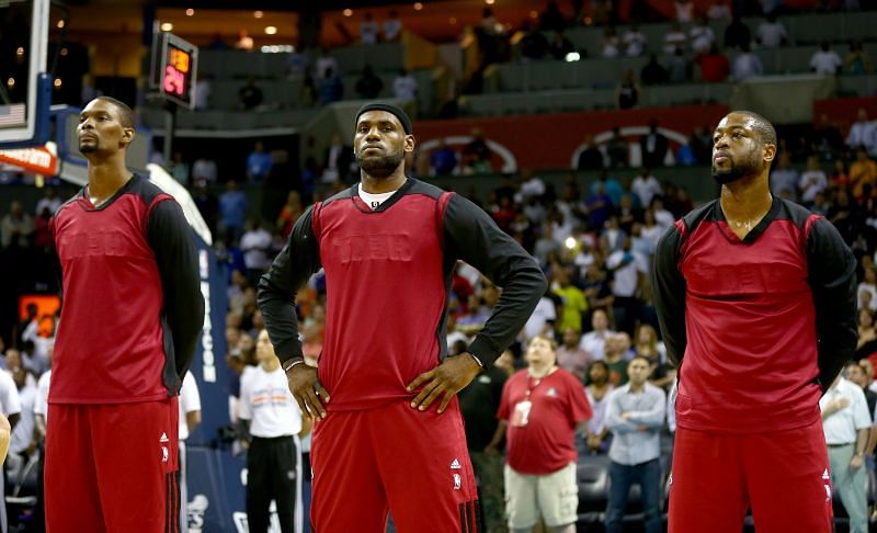 Chris Bosh (left) of the Miami Heat stands alongside teammates LeBron James and Dwyane Wade
