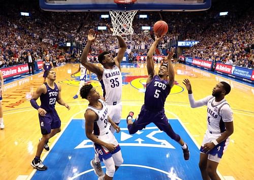 Jaire Grayer #5 of the TCU Horned Frogs shoots as Ochai Agbaji #30 of the Kansas Jayhawks defends 