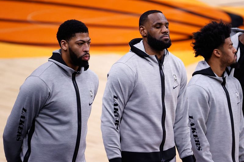 Anthony Davis and LeBron James of the Los Angeles Lakers stand attended for the national anthem before the NBA preseason game against the Phoenix Suns