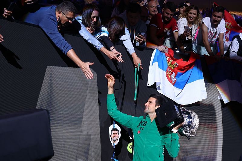 Novak Djokovic celebrates with the fans after winning the title at the 2020 Australian Open