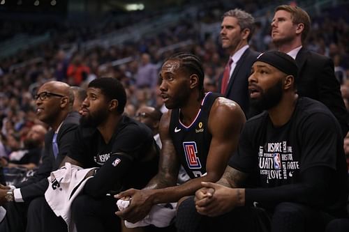 Paul George, Kawhi Leonard and Marcus Morris Sr. of the LA Clippers on the bench during the second half of the NBA game against the Phoenix Suns 