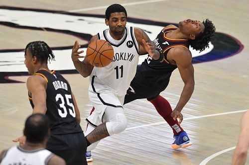 Kyrie Irving #11 of the Brooklyn Nets runs into Collin Sexton #2 of the Cleveland Cavaliers during the fourth quarter at Rocket Mortgage Fieldhouse on January 20, 2021 in Cleveland, Ohio. (Photo by Jason Miller/Getty Images)