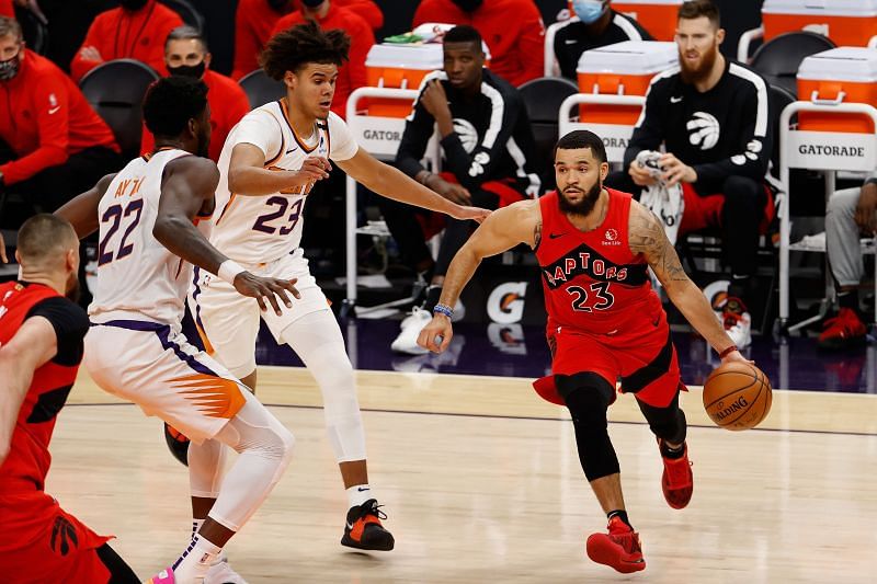 PHOENIX, ARIZONA - JANUARY 06: Fred VanVleet #23 of the Toronto Raptors moves the ball ahead of Cameron Johnson #23 of the Phoenix Suns.