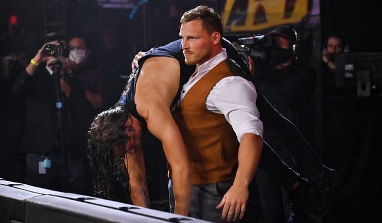 Ridge Holland carrying a beaten Adam Cole at TakeOver 31