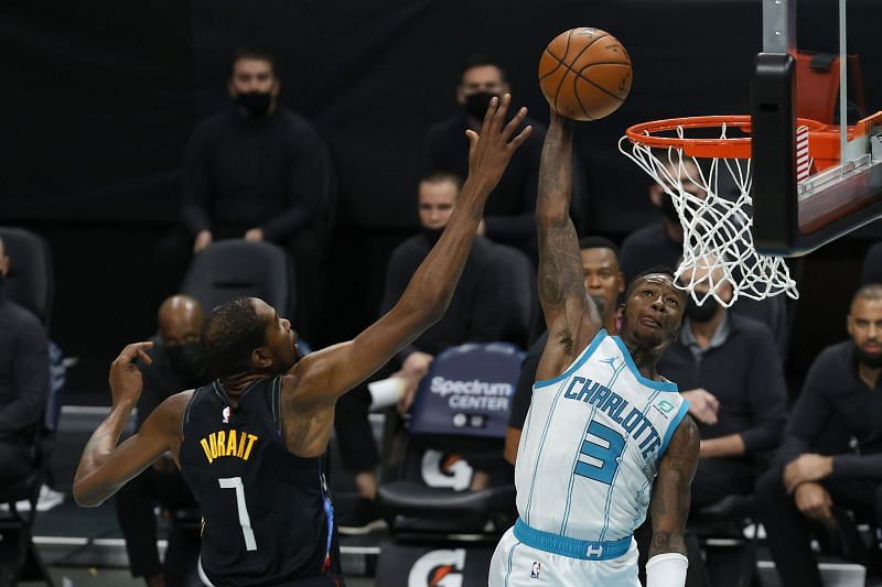 Terry Rozier #3 of the Charlotte Hornets dunks the ball against Kevin Durant #7 of the Brooklyn Nets