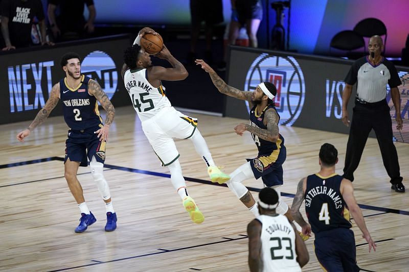 Donovan Mitchell of the Utah Jazz shoots as Lonzo Ball and Brandon Ingram #of the New Orleans Pelicans defend