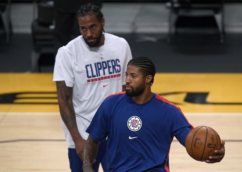Paul George and Kawhi Leonard of the LA Clippers warm up before a preseason game against the Los Angeles Lakers