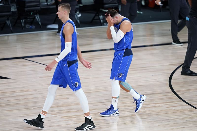 Kristaps Porzingis and Luka Doncic of the Dallas Mavericks leave the court after the first half of Game Three in the 2020 playoffs